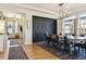 Dining room with a long dining table, decorative wall, and contemporary lighting at 4736 S Buchanan St, Aurora, CO 80016