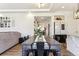 Open-concept dining room with modern décor, a large table for gatherings, and seamless flow to the kitchen at 4736 S Buchanan St, Aurora, CO 80016