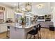 Open concept kitchen flowing into the living room featuring a granite island, modern lighting, and stainless appliances at 4736 S Buchanan St, Aurora, CO 80016