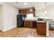 Efficiency kitchen with wood cabinets, black appliances, and a breakfast bar at 4736 S Buchanan St, Aurora, CO 80016
