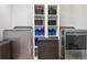 Efficient laundry room with shelving, a washer, and dryer at 4736 S Buchanan St, Aurora, CO 80016