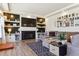 Comfortable living room featuring a modern fireplace, built-in shelves, contemporary decor, and cozy seating at 4736 S Buchanan St, Aurora, CO 80016