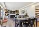 Open-concept living room with a fireplace, modern built-ins, stylish furniture, and seamless flow to the kitchen at 4736 S Buchanan St, Aurora, CO 80016
