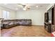 Spacious living room featuring wood-look floors, a ceiling fan, and a comfortable sectional sofa at 4736 S Buchanan St, Aurora, CO 80016