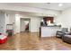Open-concept living space showcasing wood-look floors, a mini-kitchenette, and a cozy seating area at 4736 S Buchanan St, Aurora, CO 80016