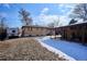 View of the backyard, patio, and campervan, with grass and light snow cover at 4133 S Kalamath Ct, Englewood, CO 80110