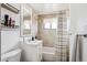 Well-lit bathroom featuring a vanity with sink, toilet, shower, and stylish mirror at 4133 S Kalamath Ct, Englewood, CO 80110