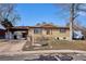 Street view of a well-maintained one-story brick home with a covered carport and small front yard at 4133 S Kalamath Ct, Englewood, CO 80110