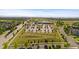 Aerial view of a community featuring parks, parking, and green spaces, surrounded by homes and distant mountains at 10065 Martin Luther King Blvd, Denver, CO 80238