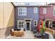 View of the back of the home showcasing the patio area and colorful exterior paint at 10065 Martin Luther King Blvd, Denver, CO 80238