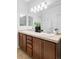 Bathroom features a double vanity, decorative mirror, and ample counter space at 10065 Martin Luther King Blvd, Denver, CO 80238
