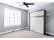 Neutral bedroom featuring a Murphy bed, a ceiling fan, and natural light at 10065 Martin Luther King Blvd, Denver, CO 80238