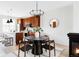 Open dining and kitchen area with cherry cabinets, a white island, and stainless appliances at 10065 Martin Luther King Blvd, Denver, CO 80238