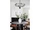 Inviting dining area features a modern chandelier, fireplace, and decorative accents at 10065 Martin Luther King Blvd, Denver, CO 80238