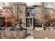 Charming townhouse showcasing a stylish brick facade, covered patio, and inviting outdoor seating area, perfect for relaxing at 10065 Martin Luther King Blvd, Denver, CO 80238
