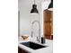 Modern kitchen featuring a stainless steel faucet, black sink, and bright white countertop at 10065 Martin Luther King Blvd, Denver, CO 80238