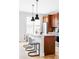 Stylish kitchen features a center island with seating, wood cabinets, and modern stainless appliances at 10065 Martin Luther King Blvd, Denver, CO 80238