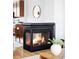 Corner fireplace with black trim, hardwood floors, and dining area in neutral color palette at 10065 Martin Luther King Blvd, Denver, CO 80238