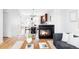 Cozy living room with hardwood floors, fireplace, dining area, and access to the kitchen at 10065 Martin Luther King Blvd, Denver, CO 80238