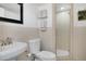 A bright bathroom with a glass enclosed shower and white tile walls at 1020 15Th St # 31E, Denver, CO 80202