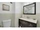 A bathroom with a dark wood vanity, white counter and tile walls at 1020 15Th St # 31E, Denver, CO 80202