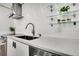 Modern kitchen featuring a stainless steel faucet, white countertops, and decorative wall accents at 1020 15Th St # 31E, Denver, CO 80202