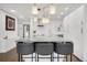 Modern kitchen features a marble island with barstool seating and contemporary lighting fixtures at 1020 15Th St # 31E, Denver, CO 80202