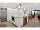 Bright, modern kitchen with stainless steel appliances, island with microwave and seating at 1020 15Th St # 31E, Denver, CO 80202