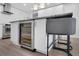 Modern kitchen island featuring a wine cooler, stone countertop, and seating at 1020 15Th St # 31E, Denver, CO 80202