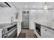 Sleek kitchen with stainless steel appliances, modern white cabinets, and a stylish island at 1020 15Th St # 31E, Denver, CO 80202