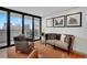 Inviting living room with neutral tones, balcony access, and city views at 1020 15Th St # 31E, Denver, CO 80202