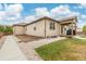 Spacious backyard featuring a covered patio, gravel landscaping, and side walkway at 646 Gamble Oak St, Brighton, CO 80601