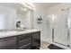 Modern bathroom featuring a double vanity with granite countertops and a glass-enclosed shower at 646 Gamble Oak St, Brighton, CO 80601