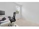 Bright room showing desk with printer with carpet flooring and large windows at 646 Gamble Oak St, Brighton, CO 80601