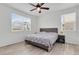 Cozy bedroom with a ceiling fan and two large windows offering natural light and view at 646 Gamble Oak St, Brighton, CO 80601
