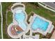 Aerial view of community pool with distinct swimming areas, lounge chairs, and lush landscaping at 646 Gamble Oak St, Brighton, CO 80601