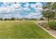 Expansive community green space with lush lawn and manicured landscaping at 646 Gamble Oak St, Brighton, CO 80601