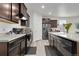 Contemporary kitchen boasts dark cabinets, stainless steel appliances, and an island at 646 Gamble Oak St, Brighton, CO 80601