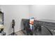 Well lit laundry room including modern gray washer and dryer sets at 646 Gamble Oak St, Brighton, CO 80601