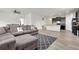 Spacious living room with a sectional sofa flowing into the kitchen at 646 Gamble Oak St, Brighton, CO 80601