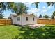 A newly fenced backyard features a well-kept lawn, with space for outdoor relaxation and entertaining at 4467 N Umatilla St, Denver, CO 80211