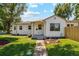 Charming home with a well-manicured lawn and inviting walkway, showing great curb appeal at 4467 N Umatilla St, Denver, CO 80211