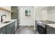 Well-designed kitchen with stainless appliances, stylish cabinetry, and a bright window overlooking the yard at 4467 N Umatilla St, Denver, CO 80211