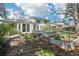 Expansive backyard garden with raised beds, adjacent to home with glass doors and windows at 14582 E Harvard Ave, Aurora, CO 80014