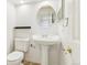 Simple bathroom with pedestal sink, toilet, and white walls at 14582 E Harvard Ave, Aurora, CO 80014
