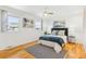 Well-lit bedroom with hardwood floors, a comfortable bed, and stylish decor at 14582 E Harvard Ave, Aurora, CO 80014