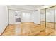 Spacious bedroom with hardwood floors, closet doors, and view into ensuite bath at 14582 E Harvard Ave, Aurora, CO 80014