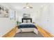 Bright bedroom features hardwood floors, ceiling fan, and ample closet space at 14582 E Harvard Ave, Aurora, CO 80014