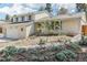 Inviting home exterior with light brick, tasteful landscaping, and a cozy covered entry at 14582 E Harvard Ave, Aurora, CO 80014