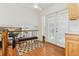 Well-lit hallway with a bench, decorative rug, and French doors to the exterior at 14582 E Harvard Ave, Aurora, CO 80014